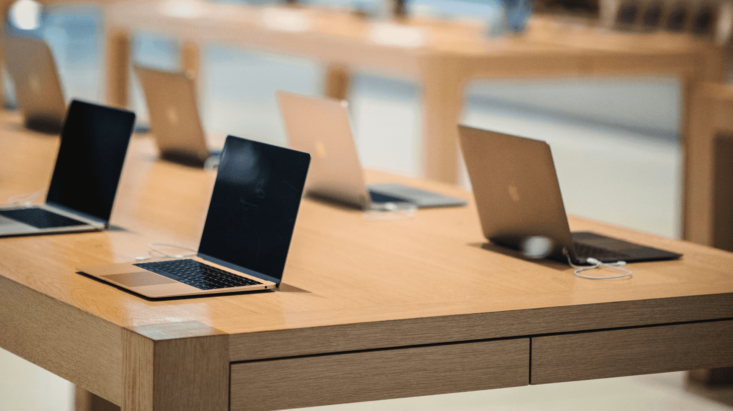 Laptop computers displayed on a retail table