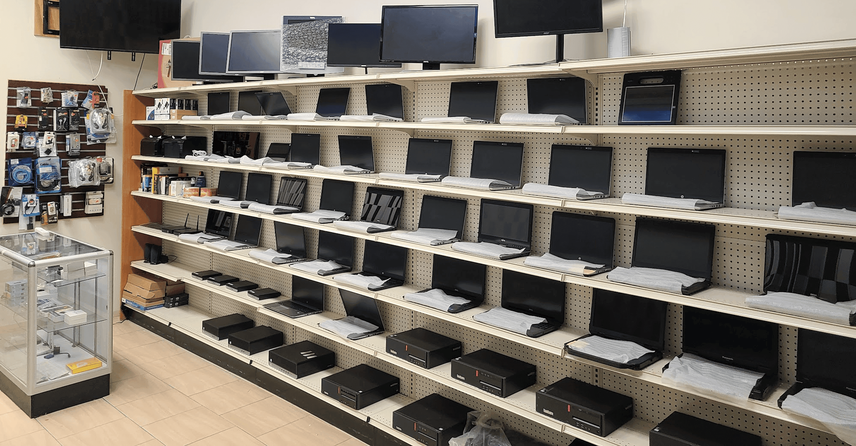Inside Tech Hub with laptops, desktops, monitors, and accessories on display